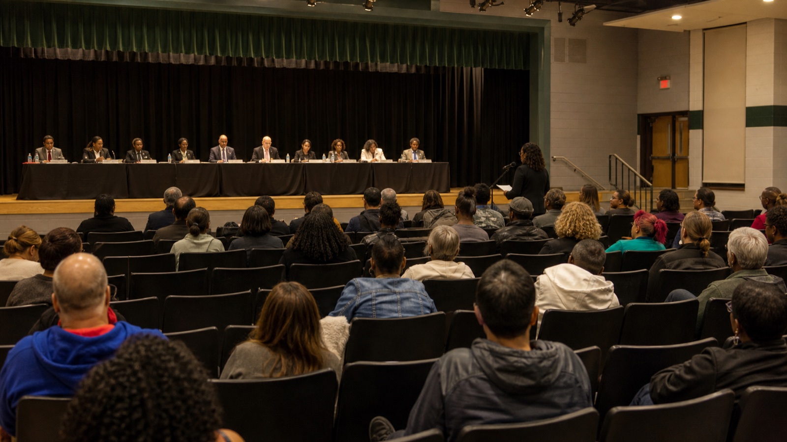 Detroit residents attending a public school board meeting